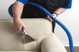 Technician performing professional upholstery cleaning